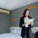 asian-housekeeping-manager-with-tablet-checking-the-room-or-suite-of-a-hotel-e1706607239474.jpg