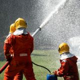 fire-fighter-team-on-training-fight-with-gas-and-oil-spray-turbulence-water-to-distinguished-fire.jpg