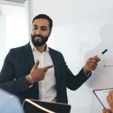 male-and-female-employees-analyzing-revenue-diagram-during-collaboration-in-board-room-.jpg