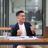 portrait-of-an-asian-male-business-owner-standing-with-a-computer-showing-happiness-after-a-e1703739122706.jpg